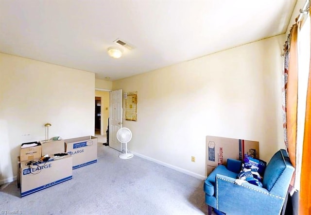 sitting room featuring visible vents, carpet, and baseboards