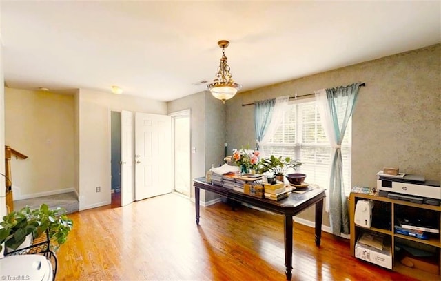 interior space with visible vents, baseboards, and wood finished floors