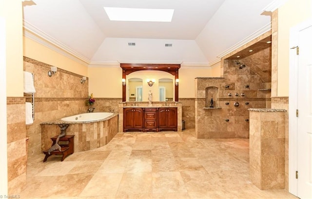 full bathroom with visible vents, a walk in shower, vanity, a bath, and tile walls