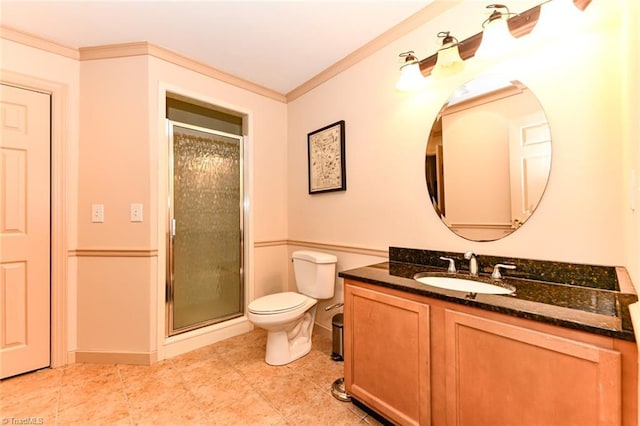 bathroom with a shower stall, vanity, toilet, and ornamental molding