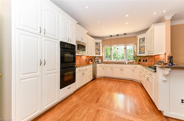 kitchen featuring ornamental molding, dark countertops, backsplash, appliances with stainless steel finishes, and glass insert cabinets