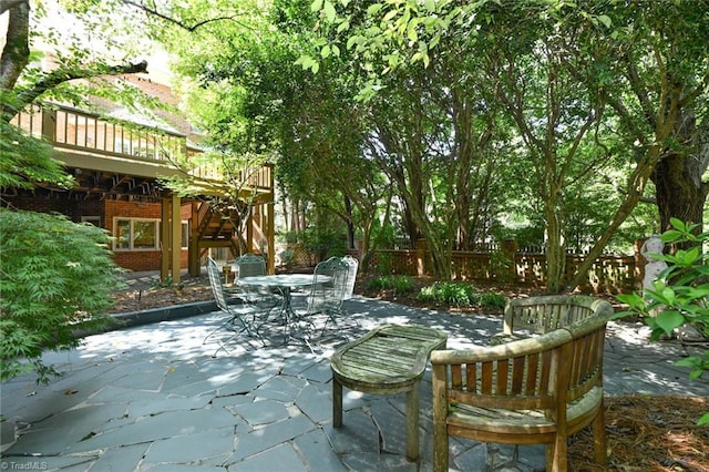 view of patio / terrace featuring stairway, outdoor dining area, a deck, and fence