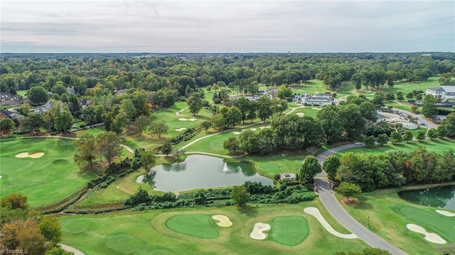 drone / aerial view featuring golf course view and a water view