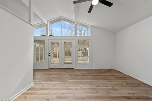 unfurnished room featuring ceiling fan, high vaulted ceiling, and light hardwood / wood-style flooring