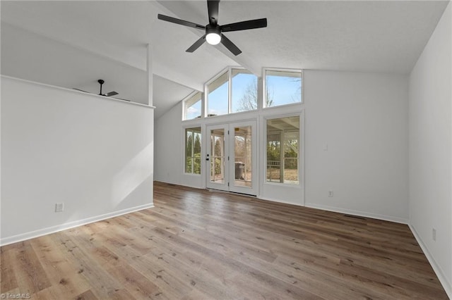 spare room with lofted ceiling with beams, ceiling fan, and hardwood / wood-style floors