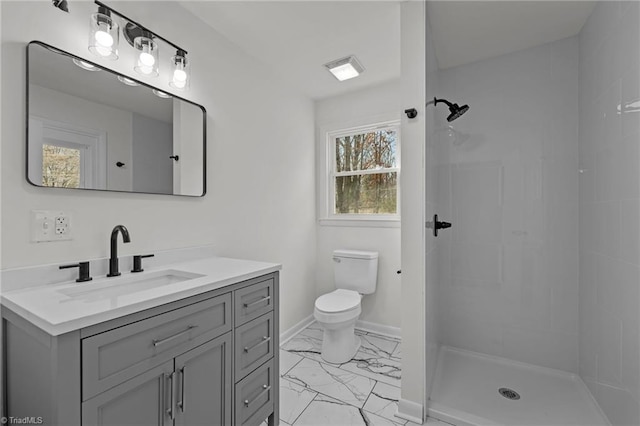 bathroom featuring vanity, a shower, and toilet