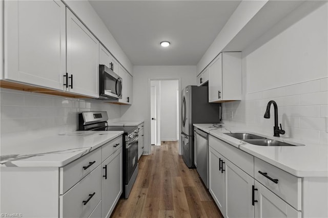 kitchen featuring sink, stainless steel appliances, and white cabinets