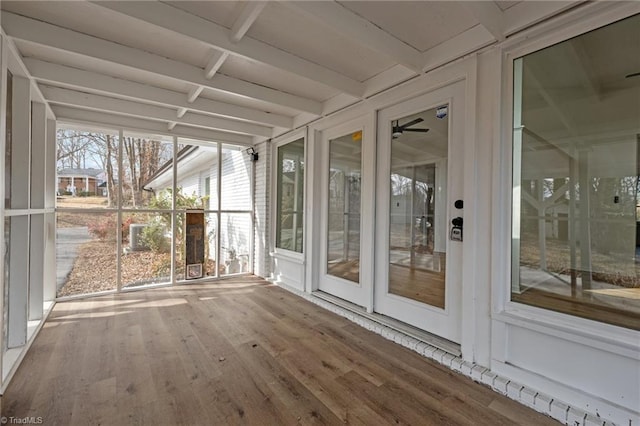 unfurnished sunroom with beam ceiling