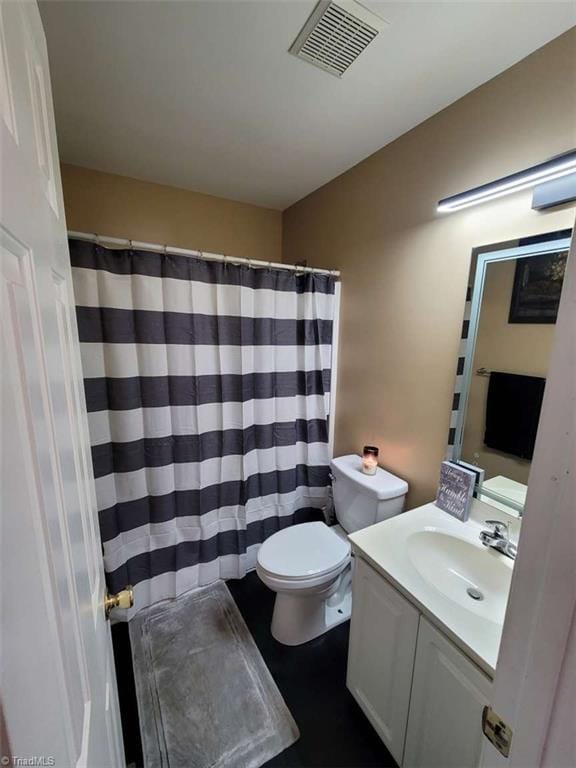 5125 Old Plantation Cir, Winston-Salem, NC 27104 - bathroom with vanity, toilet, and a shower with curtain