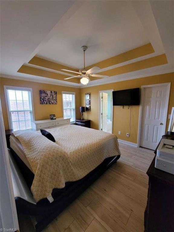 5125 Old Plantation Cir, Winston-Salem, NC 27104 - bedroom with a raised ceiling, light wood-type flooring, baseboards, a ceiling fan, and connected bathroom