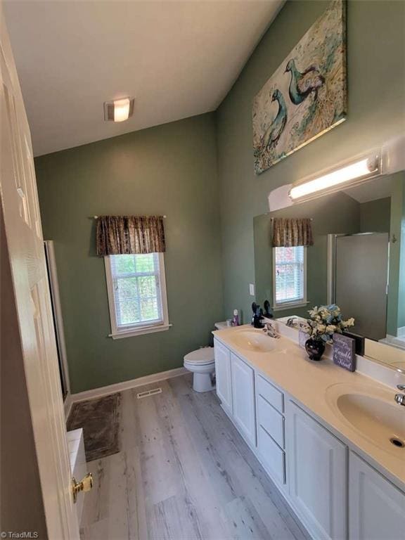 5125 Old Plantation Cir, Winston-Salem, NC 27104 - bathroom with plenty of natural light, double vanity, toilet, and wood finished floors