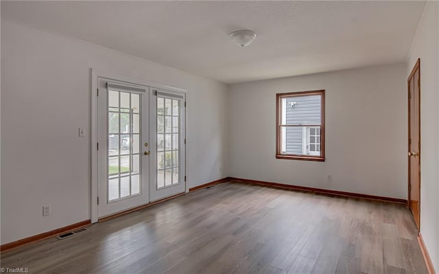 210 W Parkway Ave, High Point, NC 27284 - unfurnished room featuring french doors, wood finished floors, and baseboards