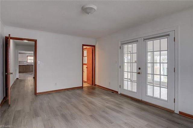 210 W Parkway Ave, High Point, NC 27284 - empty room featuring light wood-type flooring, healthy amount of natural light, and french doors