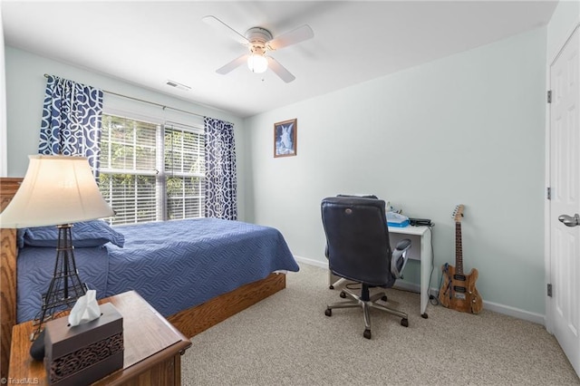 carpeted bedroom with a ceiling fan, baseboards, and visible vents