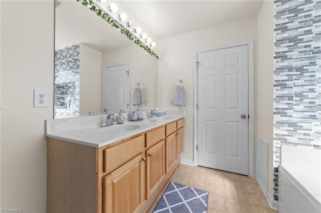 bathroom with a sink, tile patterned flooring, a tub to relax in, and double vanity