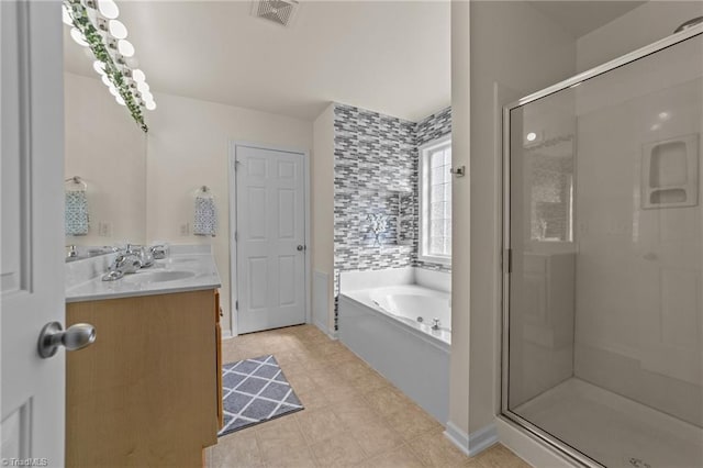 full bath with vanity, baseboards, visible vents, a bath, and a stall shower
