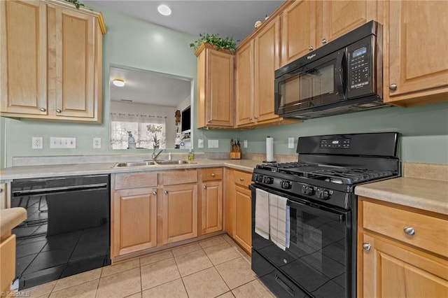 kitchen featuring light tile patterned flooring, light brown cabinets, light countertops, a sink, and black appliances