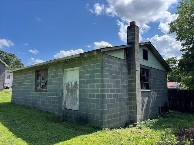 304 Ingram St, Thomasville, NC 27360 - view of side of property featuring concrete block siding and a chimney