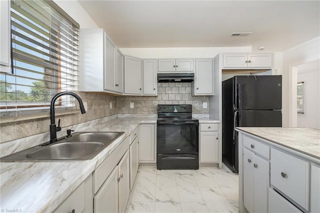 304 Ingram St, Thomasville, NC 27360 - kitchen with black appliances, under cabinet range hood, plenty of natural light, and tasteful backsplash