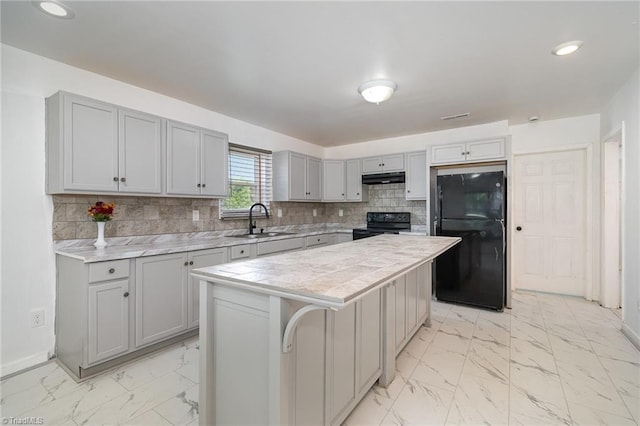 304 Ingram St, Thomasville, NC 27360 - kitchen featuring black appliances, gray cabinetry, light marble finish floors, under cabinet range hood, and light countertops
