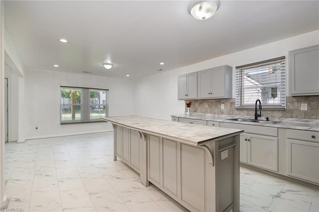 304 Ingram St, Thomasville, NC 27360 - kitchen featuring gray cabinetry, light marble finish floors, plenty of natural light, a kitchen island, and recessed lighting
