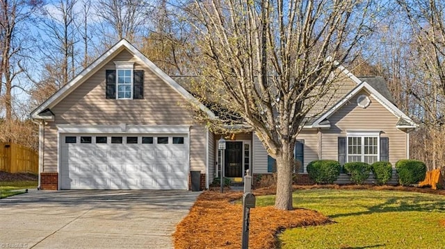 view of front facade with a garage, driveway, and a front lawn