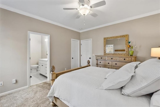 carpeted bedroom with ceiling fan, ensuite bath, baseboards, and ornamental molding