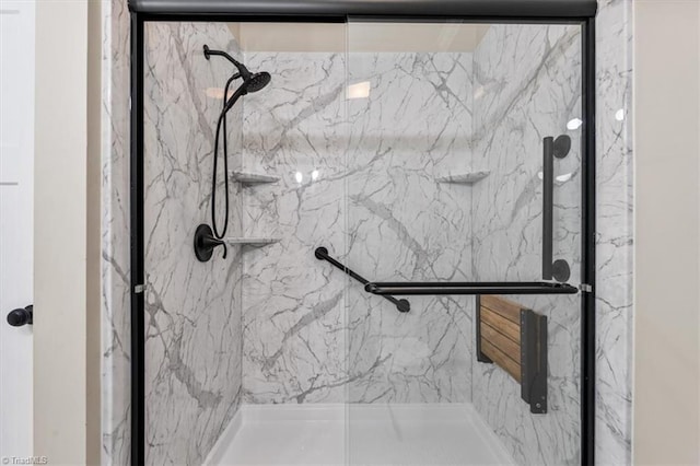 bathroom with a marble finish shower