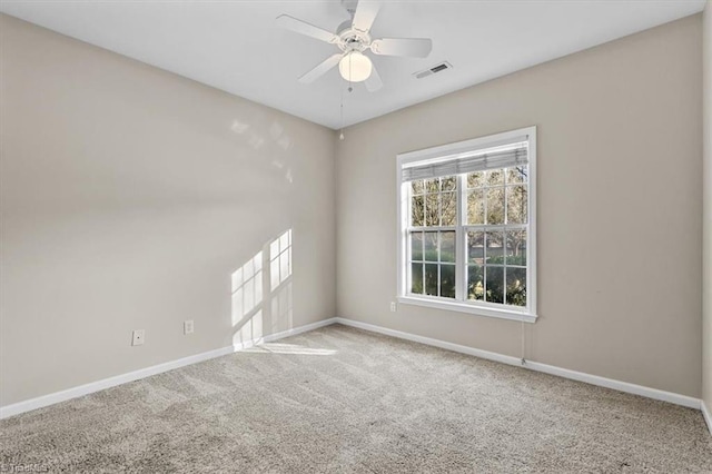 unfurnished room featuring visible vents, carpet floors, baseboards, and ceiling fan