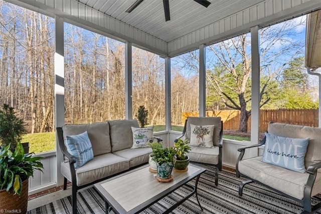 sunroom / solarium with a ceiling fan