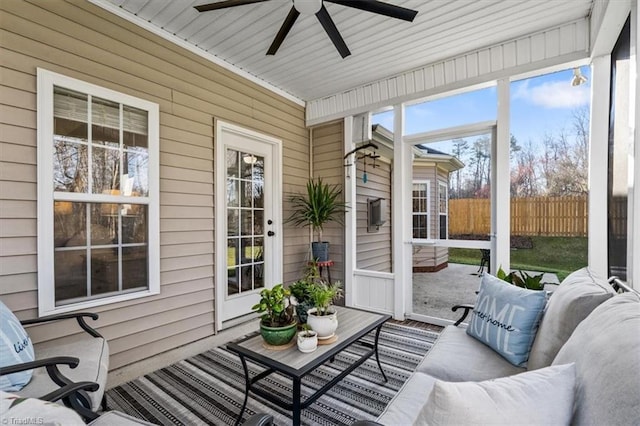 sunroom / solarium with a ceiling fan