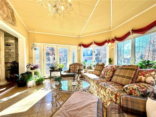 sunroom with a notable chandelier, wooden ceiling, and french doors