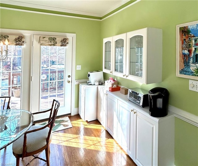 interior space featuring crown molding and light hardwood / wood-style flooring