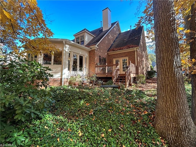 rear view of house with french doors and a wooden deck