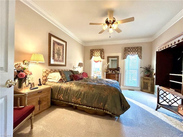 carpeted bedroom featuring ceiling fan and ornamental molding