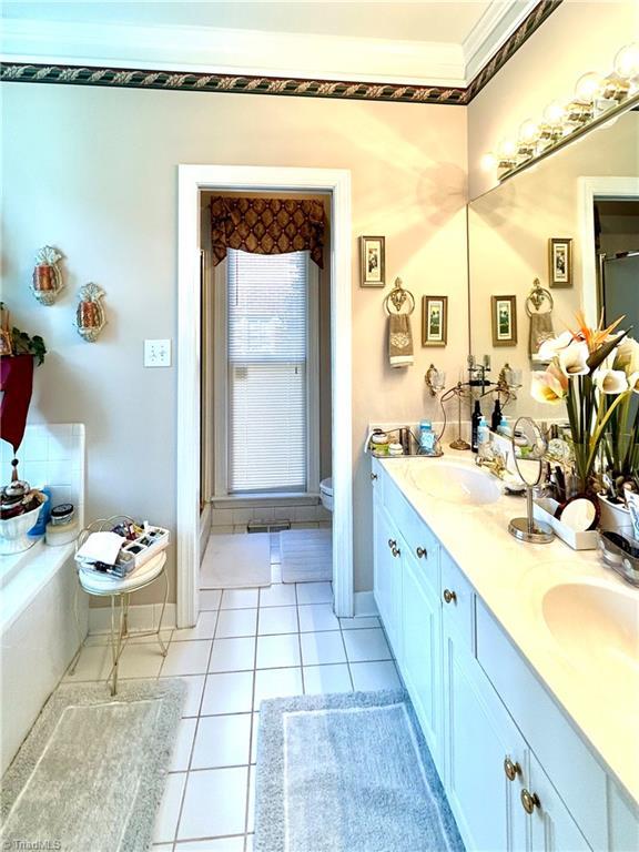 bathroom featuring tile patterned flooring, vanity, and toilet