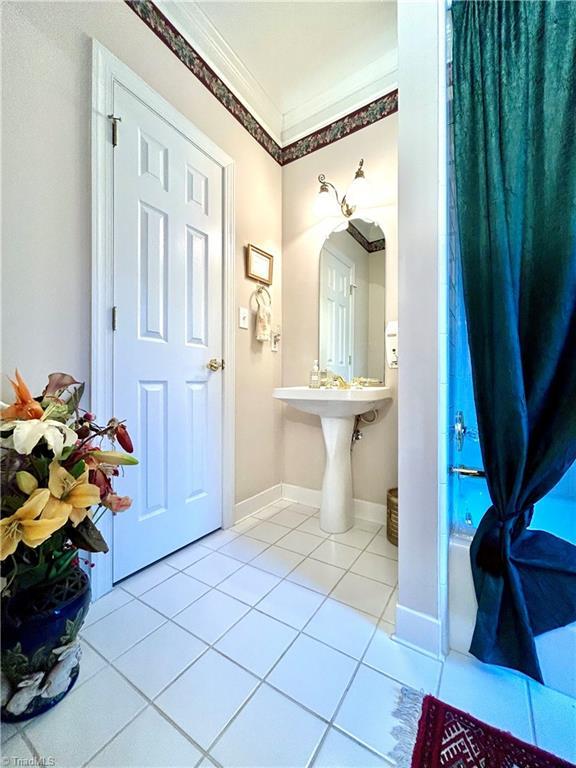 bathroom featuring tile patterned floors and ornamental molding