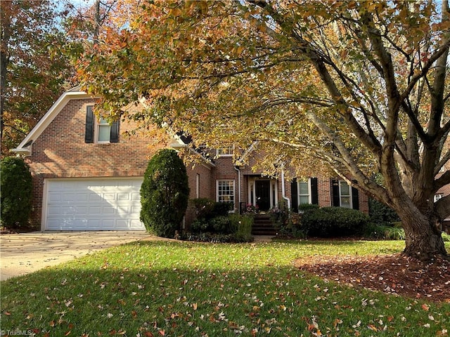 view of front of home with a front yard and a garage