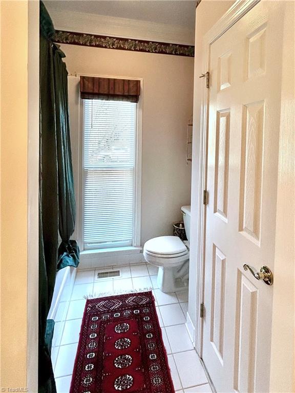 bathroom with tile patterned floors and toilet