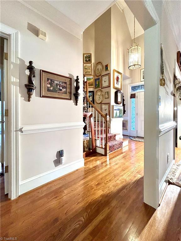 foyer with a chandelier and wood-type flooring