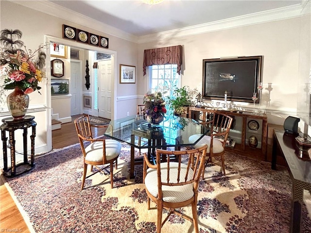 dining area featuring hardwood / wood-style floors and ornamental molding