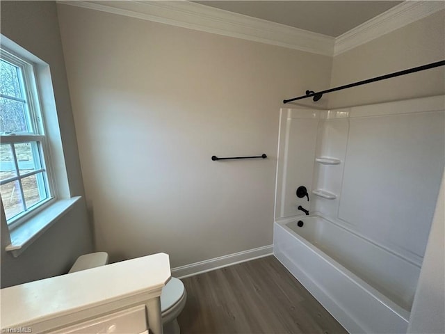 bathroom with crown molding, hardwood / wood-style flooring, shower / bathtub combination, and toilet