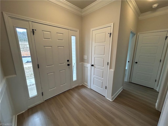 entryway featuring ornamental molding and light hardwood / wood-style floors