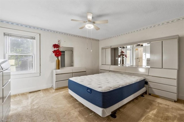 bedroom featuring baseboards, a textured ceiling, and light carpet