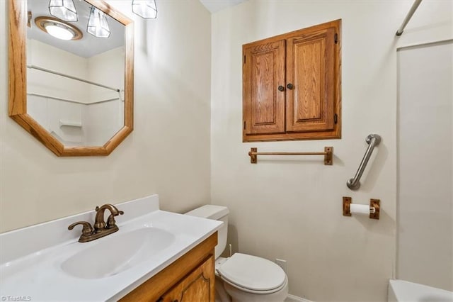 bathroom with toilet, walk in shower, and vanity