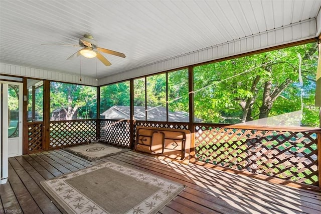 unfurnished sunroom with a ceiling fan
