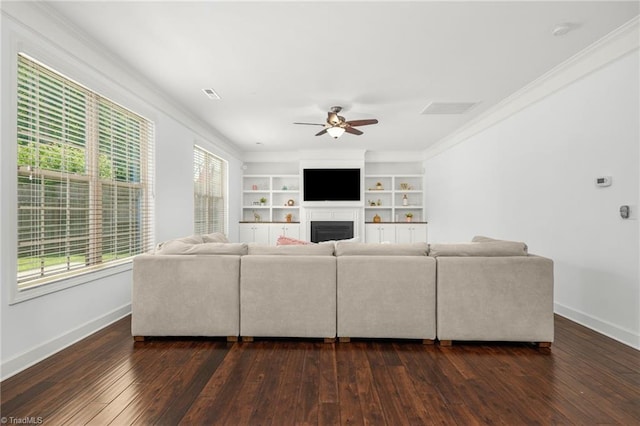301 Summerwalk Rd, Greensboro, NC 27455 - living area featuring a ceiling fan, crown molding, dark wood-type flooring, a fireplace, and built in shelves