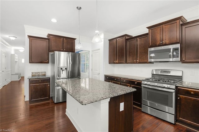 301 Summerwalk Rd, Greensboro, NC 27455 - kitchen with appliances with stainless steel finishes, ornamental molding, stone counters, a center island, and dark brown cabinets