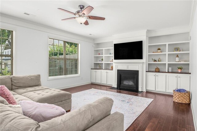 301 Summerwalk Rd, Greensboro, NC 27455 - living area featuring a ceiling fan, ornamental molding, dark wood-type flooring, and a fireplace with flush hearth