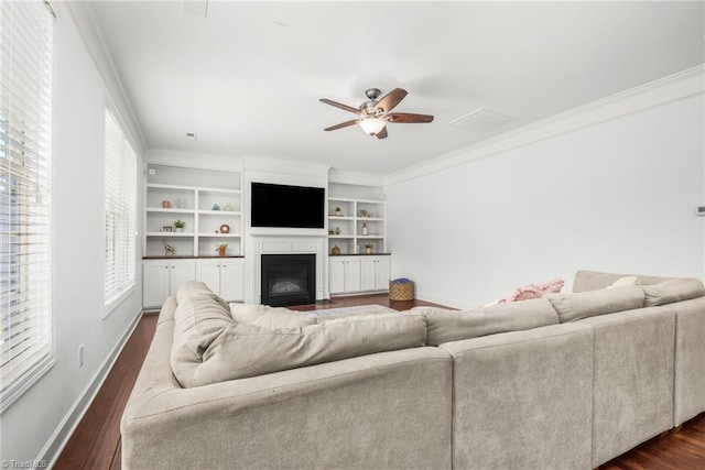 301 Summerwalk Rd, Greensboro, NC 27455 - living room featuring ornamental molding, a ceiling fan, a fireplace with flush hearth, and dark wood-style flooring